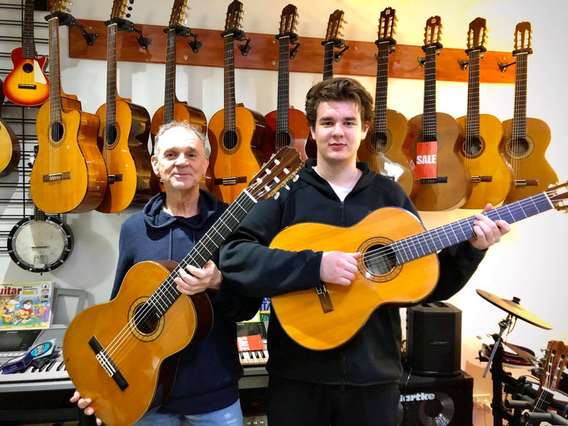 Father and son. A musical family. They bought a guitar each.  Norman with a Takamine No.5 and Nathan with a Matsuoka M35.