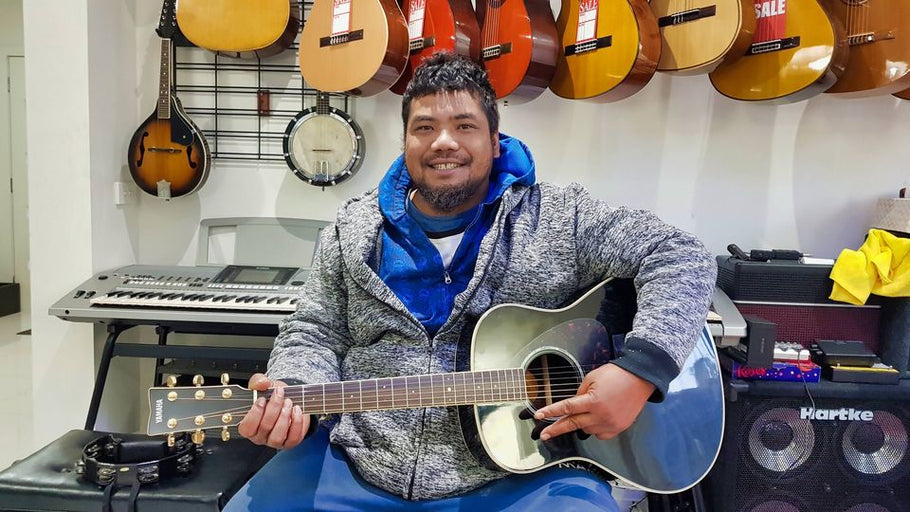 Mr Pou, from Tonga, holding his new baby, a Yamaha LL6 Luxury Line guitar with Solid Engelmann Spruce A.R.E. top and built-in pickup.