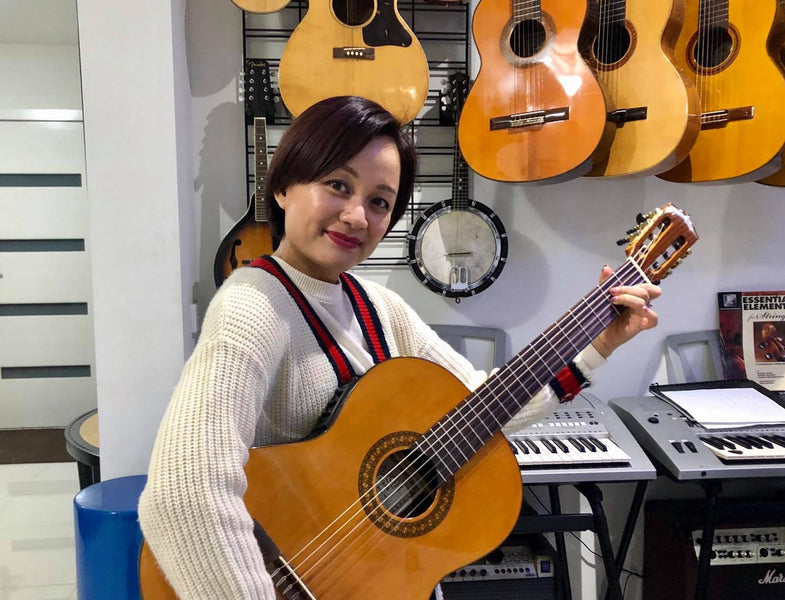 Ms Thao Nguyen with a Katoh MCG-35E Custom electric classical guitar